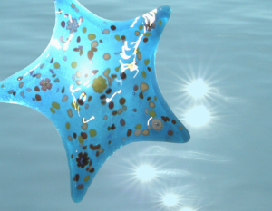 Durham Singers concert image: Venetian glass star on sunlit water background